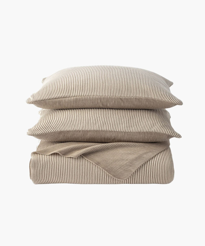 Stacked image of two shams atop the coverlet, emphasizing the knit ribbing and coordinated design in a cream tone. | Wildwood Home Co.