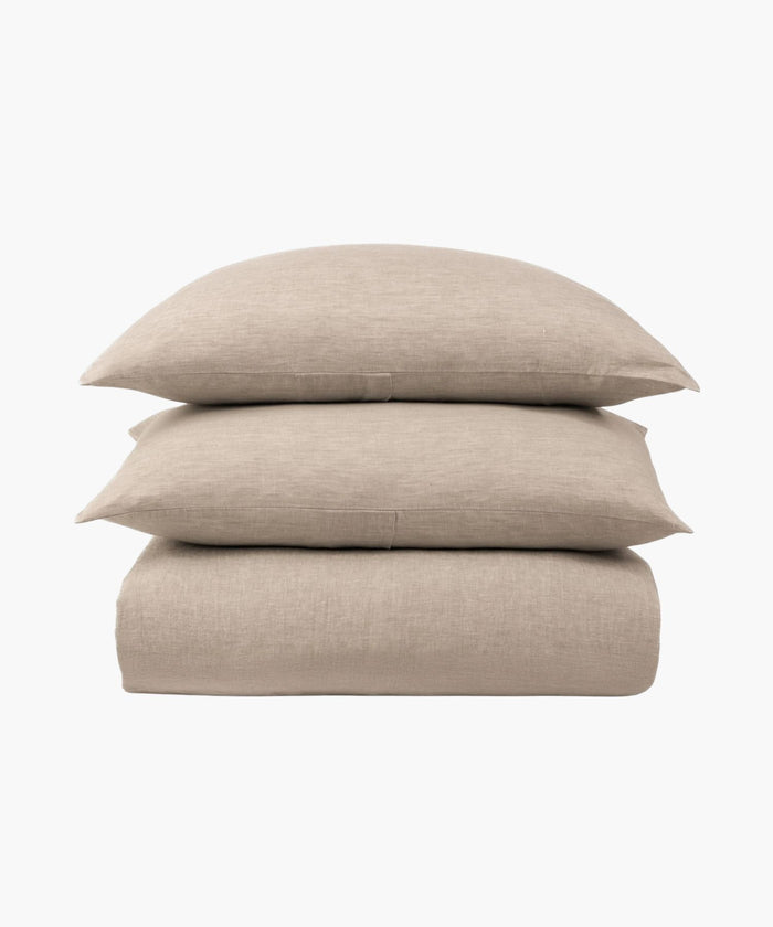 Beige bed sheet set with two pillows on a white background. | Wildwood Home Co.