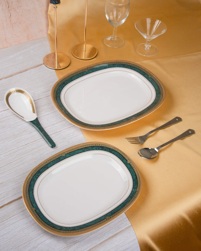 Oval melamine serving plate with white center, green rim, and gold border trim