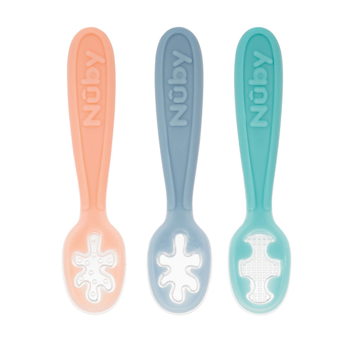 The Nuby Baby's First Spoons set includes three self-feeding utensils in Aqua, Peach, and Light Blue, each with textured scoops and the Nuby name embossed on the handles—ideal for little ones learning to eat.