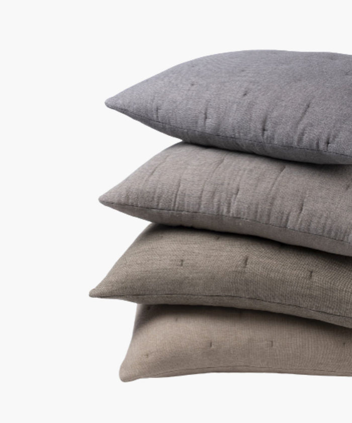 Stack pillows  ranging from beige to grey on a light background. | Wildwood Home Co.