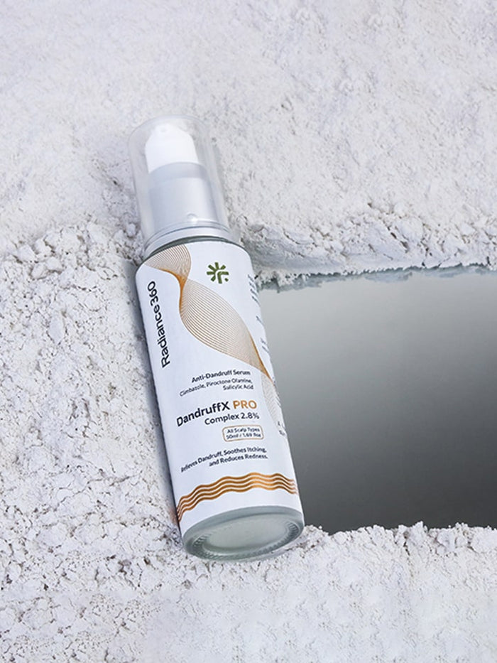 Skincare serum bottle labeled 'qndrufix pro' on a textured white surface