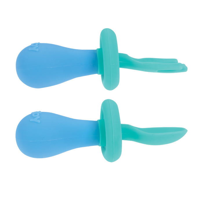 The First Fork & Spoon Set—two blue and teal silicone self-feeding utensils with rounded handles—includes a baby fork with a split tip and a solid-tip spoon, shown side by side on a white background.