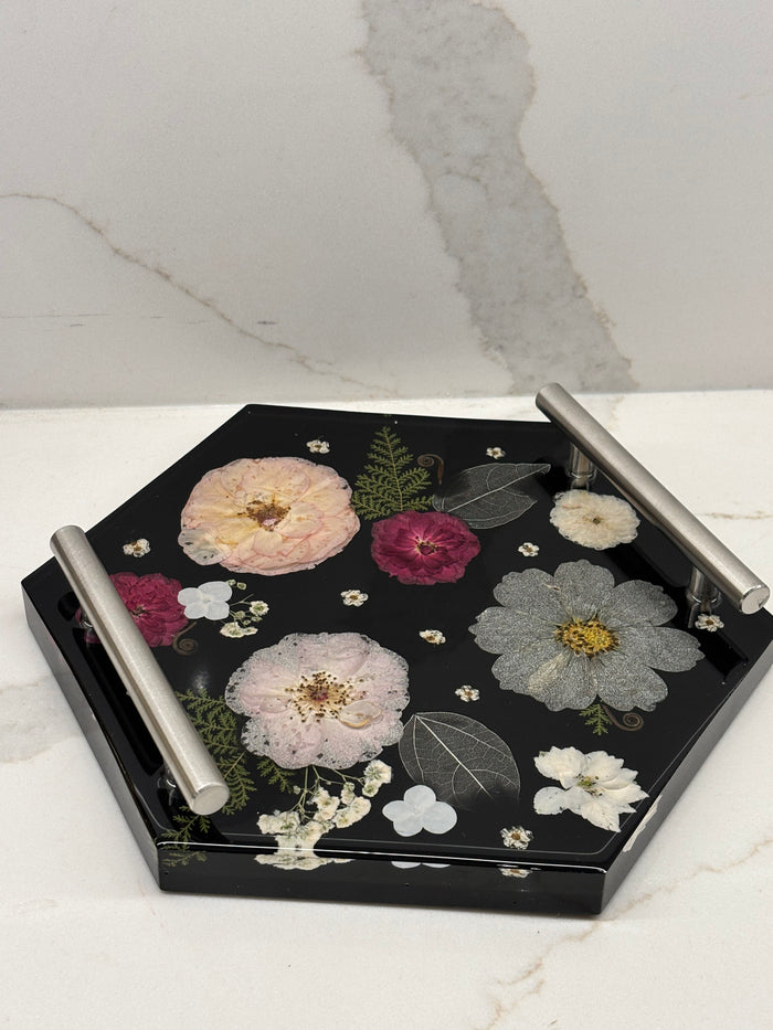 Hexagonal tray with floral design on a marble surface