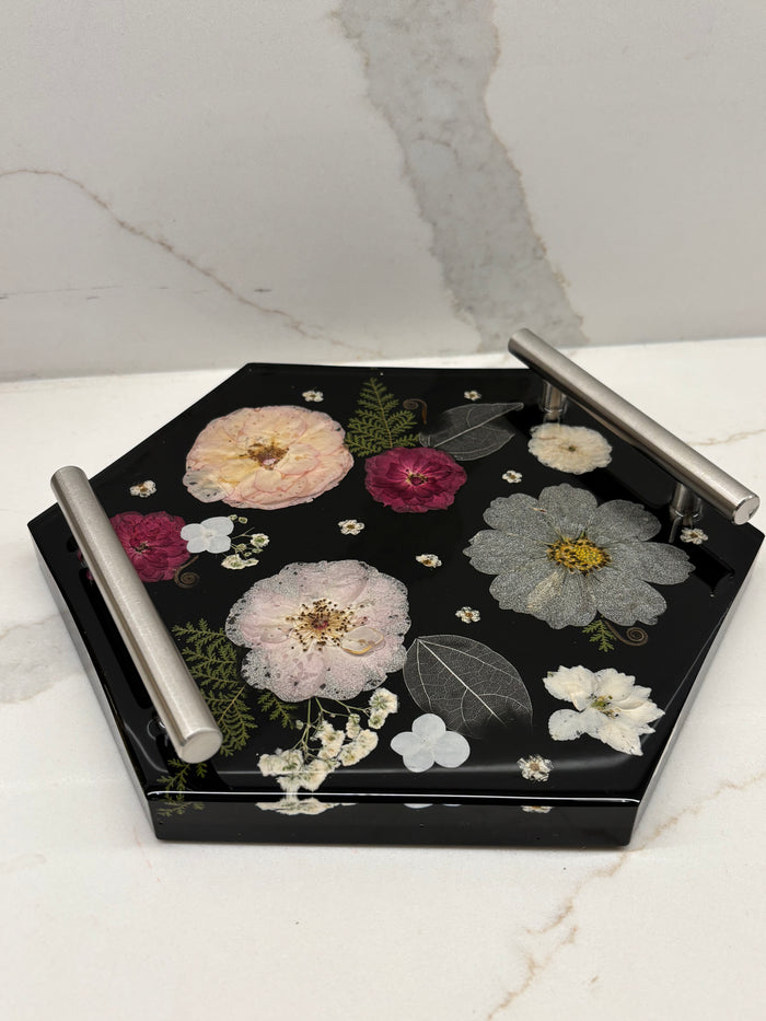 Decorative tray with floral designs on a marble surface