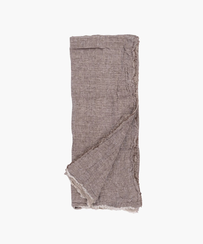 Flat lay of the Kent Super Throw in natural brown linen tone, highlighting its oversized linen gauze texture and soft fringed edges. | Wildwood Home Co.