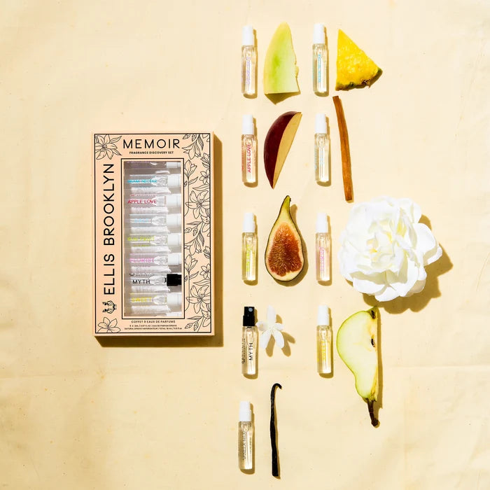 Memoir Fragrance Discovery Set box with beige and black floral design next to Dear Sky Eau De Parfum 1.5ml Vial, Miami Nectar Eau De Parfum 1.5ml Vial, Apple Love Eau De Parfum 1.5ml Vial, Salt Eau De Parfum 1.5ml Vial, Sun Fruit Eau De Parfum 1.5ml Vial, Florist Eau De Parfum 1.5ml Vial, Myth Eau De Parfum 1.5ml Vial, Sweet Eau De Parfum 1.5ml Vial, and Vanilla Milk Eau De Parfum 1.5ml Vial, on yellow background with fig, white flower, honeydew, vanilla bean, sandalwood, pineapple, and apple.