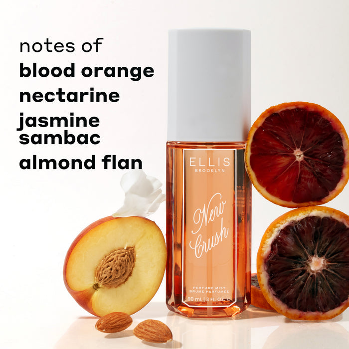 NEW CRUSH Perfume Mist 90ml between sliced blood oranges, sliced nectarine, white flower petal and almonds against white background with black text that reads "notes of blood orange, nectarine, jasmine sambac, almond flan"