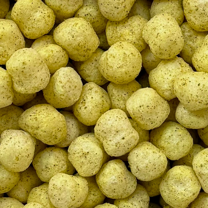 Close-up of yellow cereal sorghum puffs, crunchy, lemon herb flavor, savor snack, gluten-free