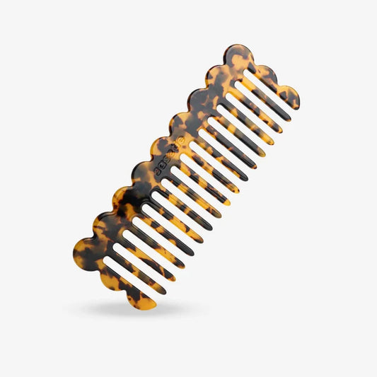 Recycled plastic hair comb on white background